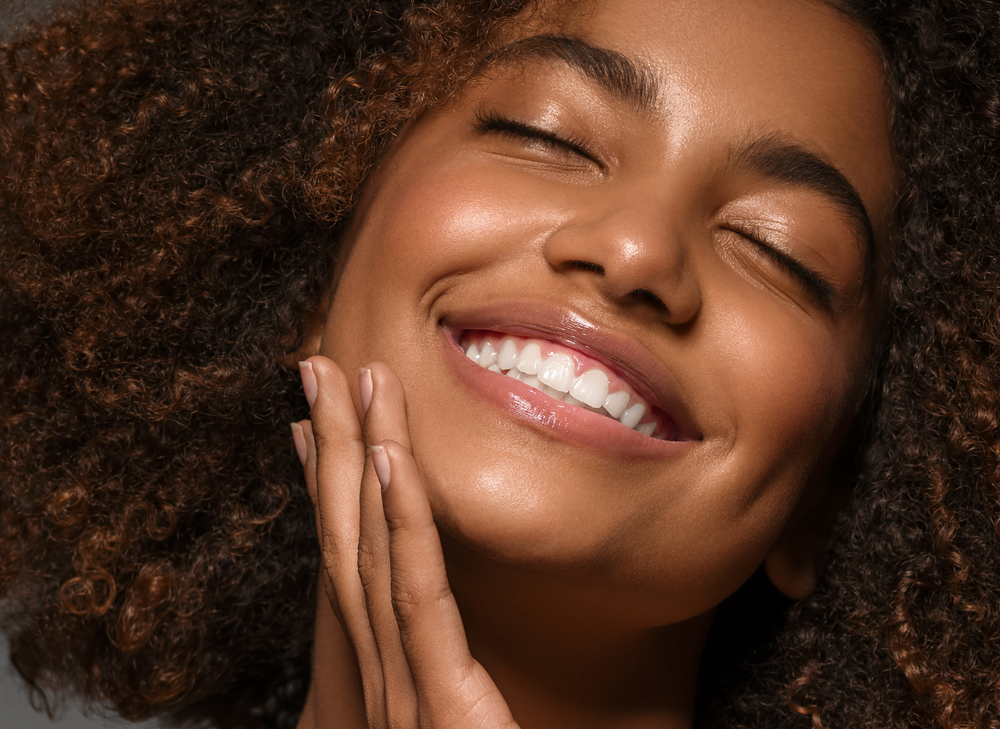 Radiant Smile After Dental Bridges Close-up of a joyful woman smiling with perfect teeth, showcasing the natural results of dental bridges - Bridges