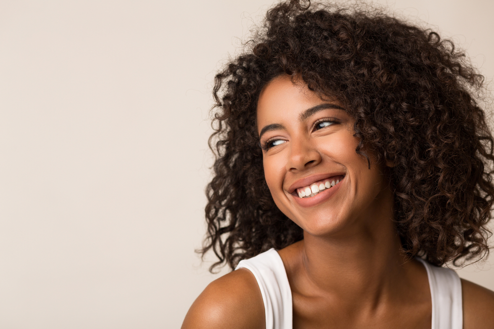 Confident Smiles with Dental Bonding Smiling woman with natural teeth showing results of dental bonding