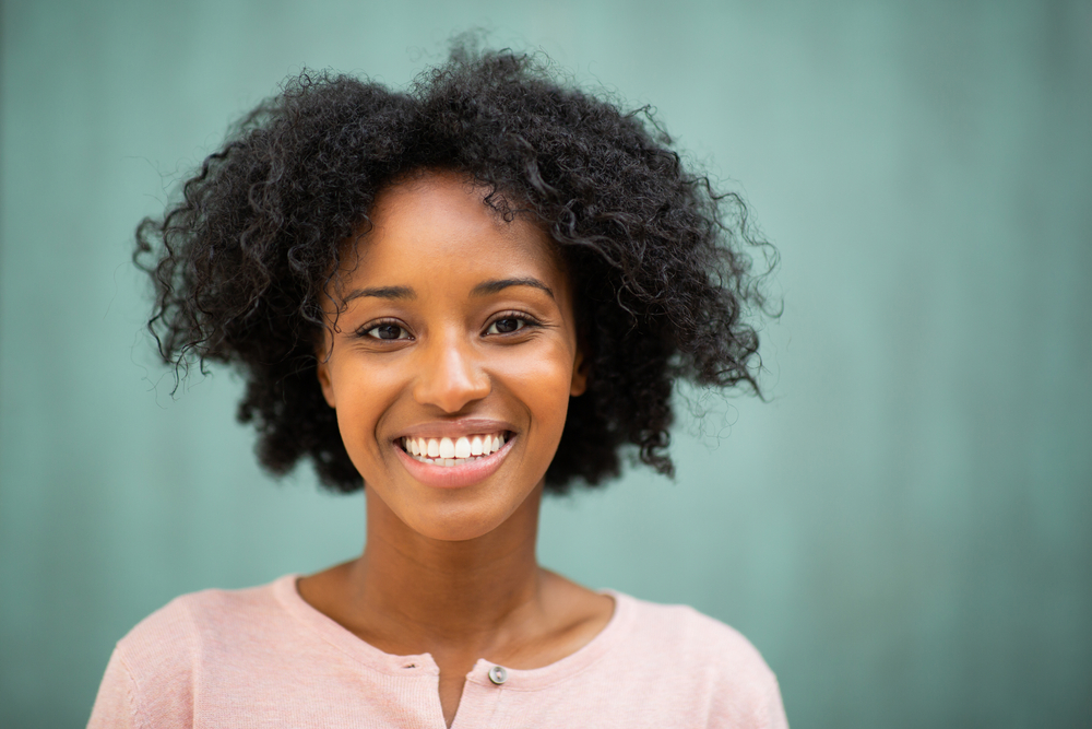 Healthy Smile After Cleaning and Exams Woman smiling confidently after receiving a professional dental cleaning and exam