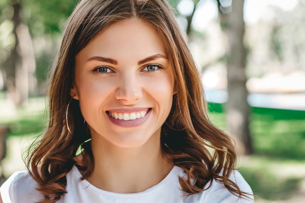 Closeup portrait of a happy young woman - Dentures Bellevue WA Closeup portrait of a happy young woman - Dentures Bellevue WA
